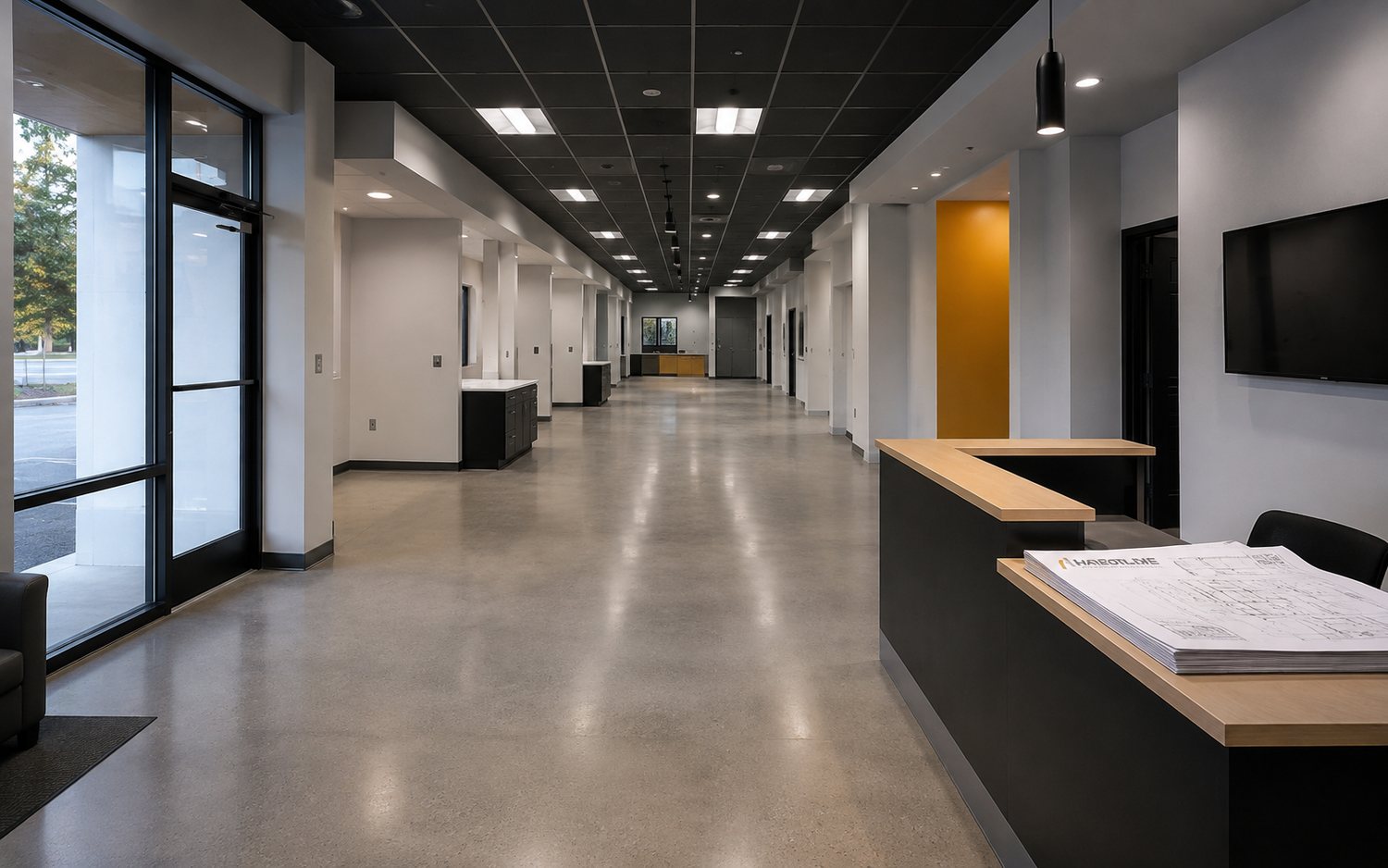 A finished office corridor with reception casework and private suites, ready for staff to occupy after a cutover